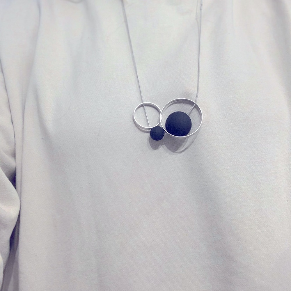 Lovely Pursuit of Happiness silver and black geo necklace.